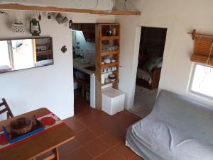 a small room with a bed and a table at El Navegante in Cabo Polonio