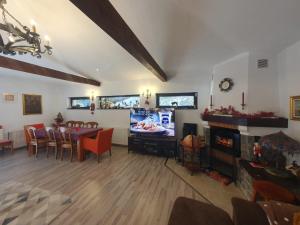 a living room with a table and a dining room at Vila PATRICIA in Breaza