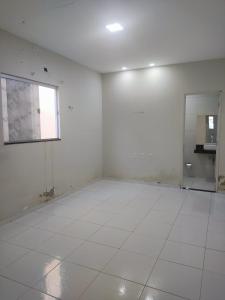 a white room with a window and a white tile floor at Casa para período de carnaval de caicó in Caicó