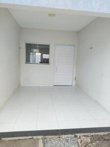 a white room with a door and a window at Casa para período de carnaval de caicó in Caicó