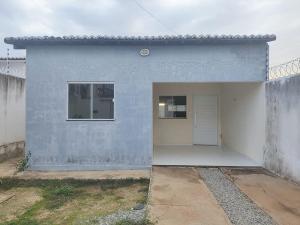 a blue and white building with a white door at Casa para período de carnaval de caicó in Caicó