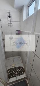 a bathroom with a shower with a black and white floor at Casa Memmar in Acapulco