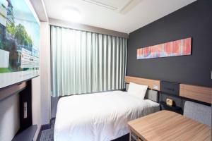 Postel nebo postele na pokoji v ubytování Washington R&B Hotel Umeda East