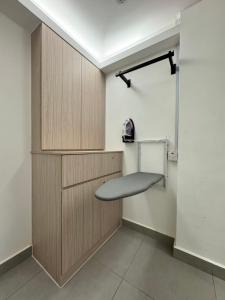 a room with wooden cabinets and a bench at Maca Hotel by Sky Hive in George Town