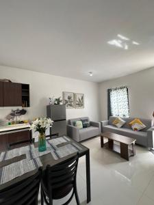a living room with a table and a couch at Almond drive 2BR Townhouse Near SRP Nustar Talisay in Talisay