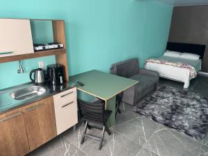 a kitchen with a table and a couch in a room at Flats e Residence - Apartamento novo in Passo Fundo +11 photos