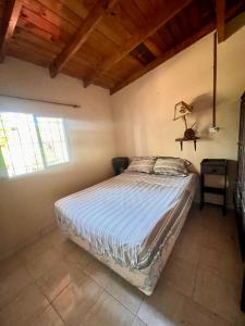 a bedroom with a bed in a room with a window at Casa Rústica para 8 personas in Mar Azul