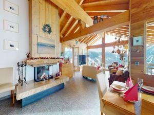 a living room with a fireplace in a house at Lush chalet in Heremence with sauna in Hérémence