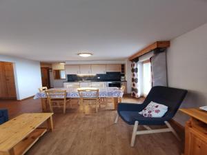 a living room with a dining table and a kitchen at Spacious apartment in Nendaz in Nendaz