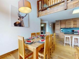 a dining room with a table and a deer on the wall at Duplex apartment in Veysonnaz in Veysonnaz