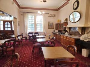 a restaurant with tables and chairs in a room at Georgian Court Inn in Melbourne