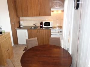 a kitchen with a wooden table with chairs and a sink at Studio in Veysonnaz by Ski Slopes & Gondola in Veysonnaz +6 photos