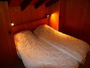 a small bedroom with a bed in a room at Family apartment with terrace in Veysonnaz