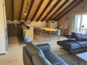 a living room with a couch and a table at Family apartment with terrace in Veysonnaz