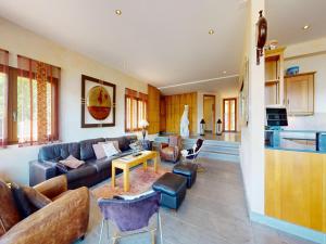 a living room with a couch and a table at Majestic chalet with indoor pool in Nendaz