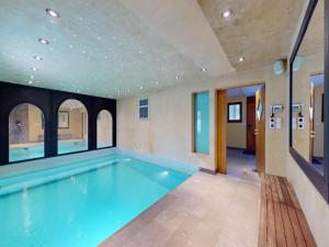an indoor swimming pool in a house with a ceiling at Majestic chalet with indoor pool in Nendaz