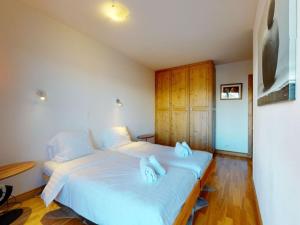 a bedroom with a large bed with towels on it at Apartment in Veysonnaz with Ski-In Ski-Out in Veysonnaz
