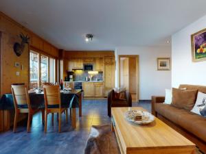 a living room with a couch and a table at Apartment in Veysonnaz with Ski-In Ski-Out in Veysonnaz +18 photos