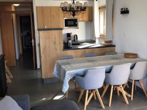 a kitchen with a table and chairs in a room at Apartment in Swiss Alps near Cable Car in Veysonnaz +21 photos