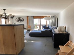 a living room with a couch and a table at Apartment in Swiss Alps near Cable Car in Veysonnaz