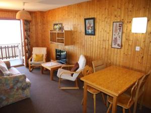 a living room with wooden walls and a table and chairs at Apartment in Swiss Alps near Cable Car in Veysonnaz