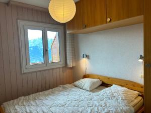 a bedroom with a large bed with a window at Apartment in Veysonnaz with balcony in Veysonnaz