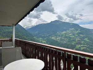 a balcony with a table and a view of a mountain at Apartment in Veysonnaz with balcony in Veysonnaz