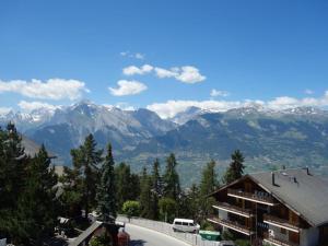 a view of a mountain range with a building at Centrally-located apartment in Veysonnaz in Veysonnaz