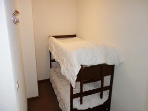 a small room with two bunk beds in it at Centrally-located apartment in Veysonnaz in Veysonnaz
