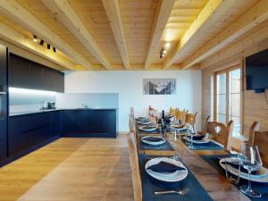 a large dining room with a long table and chairs at Nice apartment with balcony in Nendaz