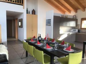 a dining room with a table with red napkins on it at Authentic Apartment With Mountain View in Veysonnaz +32 photos