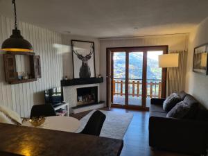 a living room with a couch and a table at Flat in Veysonnaz near Ski Lift & Valley Views in Veysonnaz