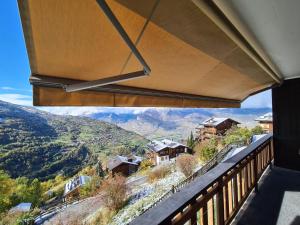 a balcony with a view of the mountains at Flat in Veysonnaz near Ski Lift & Valley Views in Veysonnaz