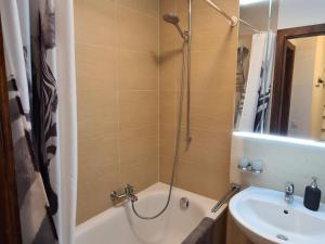 a bathroom with a tub and a sink and a shower at Flat in Veysonnaz near Ski Lift & Valley Views in Veysonnaz