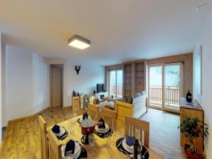 a living room with a table and chairs at Pleasant apartment in Versonnaz in Veysonnaz
