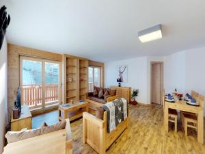 a living room with a couch and a table at Pleasant apartment in Versonnaz in Veysonnaz