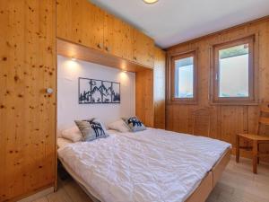 a bedroom with a bed in a wooden wall at Nice apartment with valley view in Veysonnaz