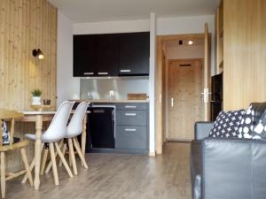 a kitchen with a table and some chairs in a room at Studio in Veysonnaz near Ski Lift in Veysonnaz