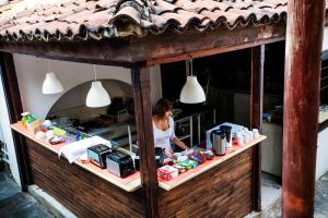 a woman is standing behind a counter in a store at Guest House Old Plovdiv in Plovdiv