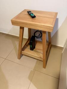 a small wooden table with a remote control on it at Departamento Calido y luminoso in Concepción del Uruguay