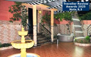 a fountain in front of a building with a staircase at Villa Dar Lghzal Private Villa with Garden, Rooftop & Authentic Dining in Rabat in Rabat +90 photos