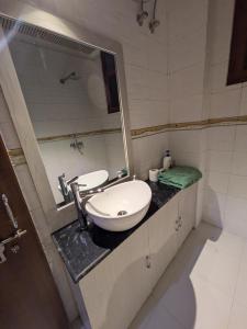 a bathroom with a sink and a mirror at Mulberry Garden in Varanasi