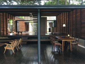 a room with a wooden table and chairs and a dining room at Ganga-Langa in Panadura