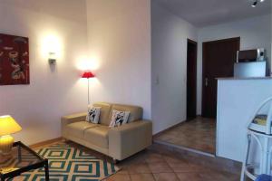 a living room with a couch and a table at Magique Creek, piscine naturelle dans les rochers in Zonza