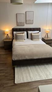 a bedroom with a large bed with two lamps at Modern studio in popular South Kensington location in London