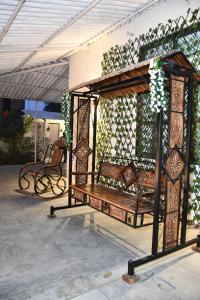 a gazebo with a bench on a patio at GC Farms in Ayodhya +21 photos