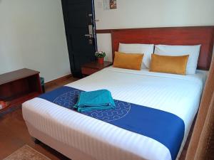 Postel nebo postele na pokoji v ubytování Melur Inn