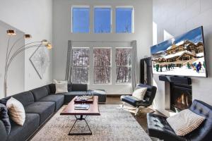 a living room with a couch and a tv at Retreat at Jordanelle 1157 in Kamas