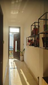 a hallway with a door and a potted plant at Phe's House in Danang