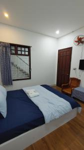 a bedroom with a large bed and a window at Phe's House in Danang